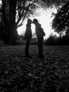Two lovers kissing in fall